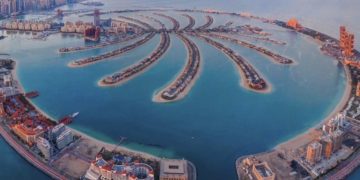 Aerial view of Palm Jumeirah in Dubai, its fronds reaching into turquoise sea